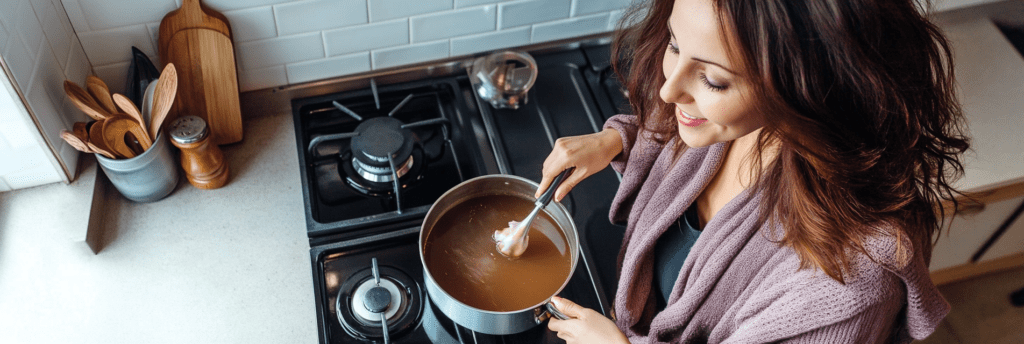 woman stirring broth on stovetop