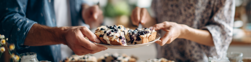 2 people sharing a plate of Keto Blueberry lemon bread